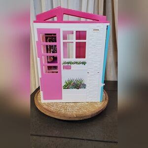 Pink and White Dollhouse with Floral Accents